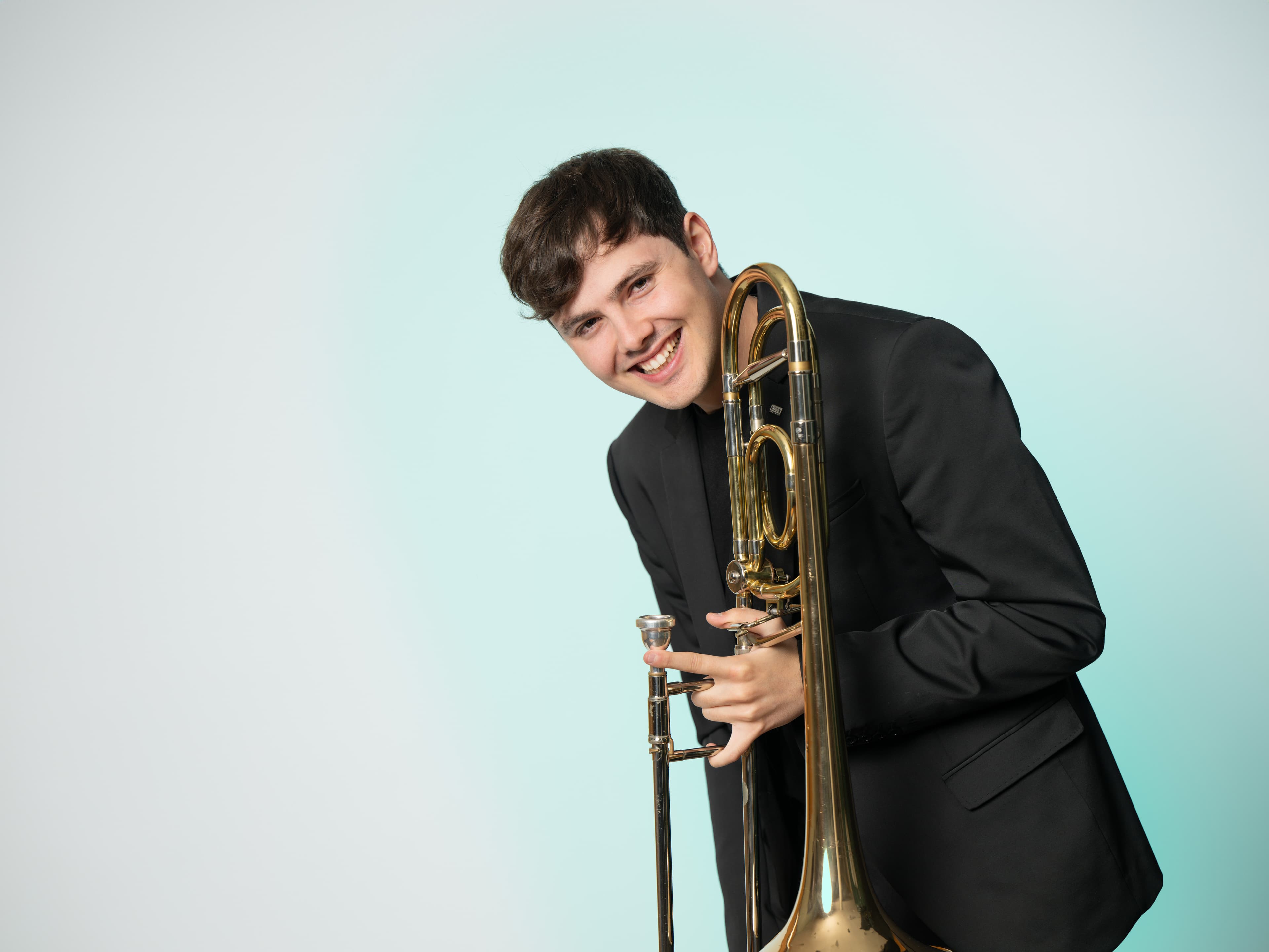 Victor Alegría, studio portrait with trombone